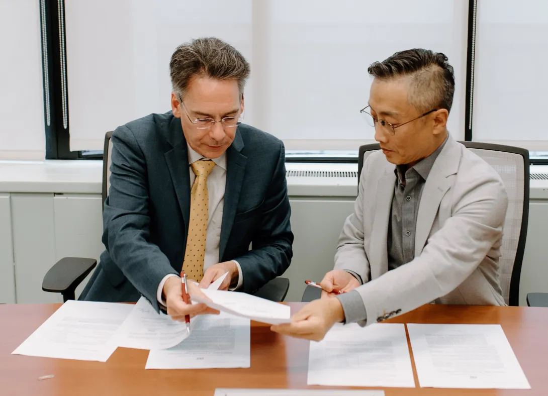 Two people have a discussion over contracts